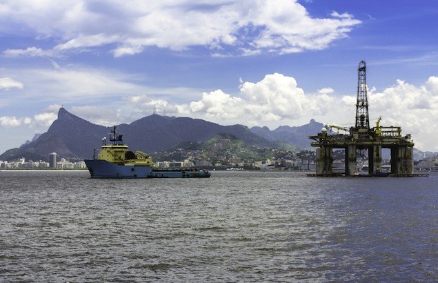 An oil rig being towed against the against panorama of Rio De Janeiro. Image (c) S