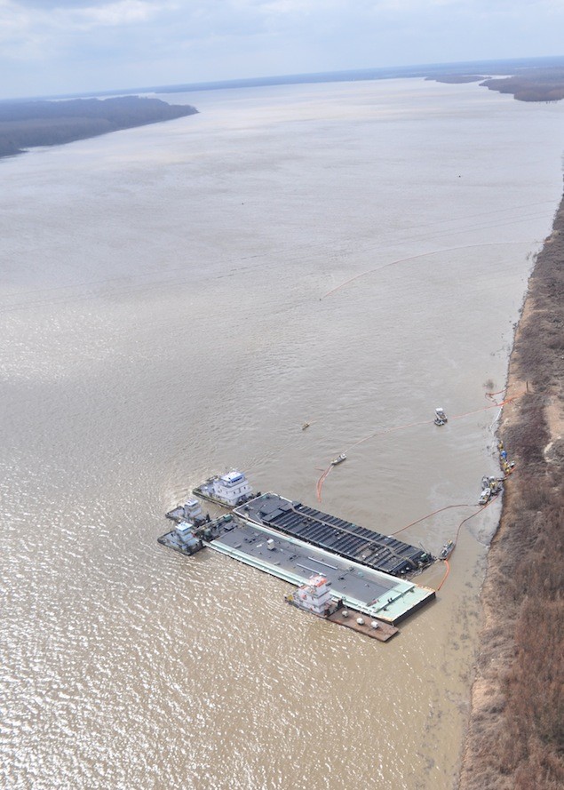 VICKSBURG, Miss. – Unified Command response vessels skim oil released from the MOC-12 barge in the Mississippi River near mile marker 436 Tuesday. Response crews have deployed 2,800 feet of boom to contain the source of the oil leak. U.S. Coast Guard photo.