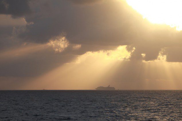 The tugs Resolve Pioneer and Dabhol tow and steer the 893-foot Carnival Triumph cruise ship Tuesday morning, Feb. 12, 2013, in the Gulf of Mexico. The ship is enroute to Mobile, Ala., after an engine room fire a few days prior. U.S. Coast Guard photo by Ensign Chris Shivock.