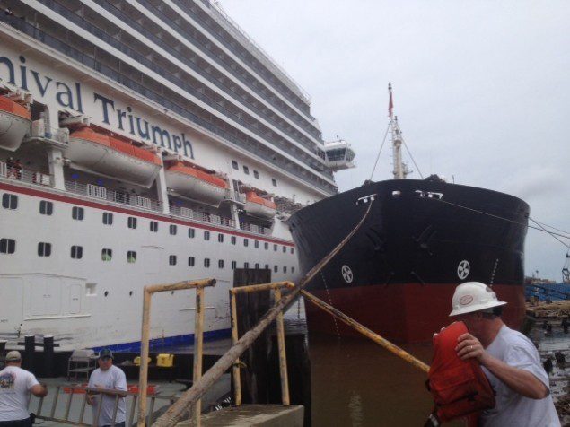 Carnival Triumph wedged up against the USACE dredger, "Wheeler", on April 3, 2013. U.S. Coast Guard Photo